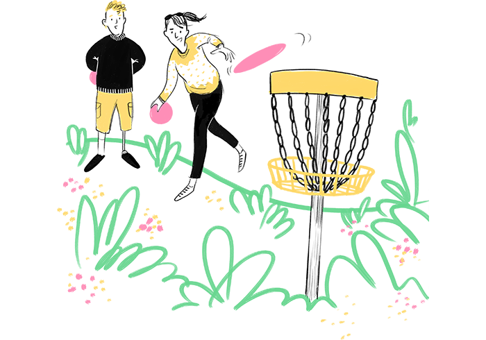 Girl and boy playing disc golf