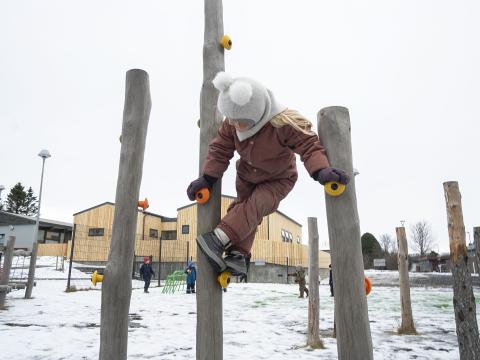preschool child playing outside in winter
