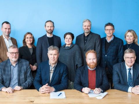 Fólk að undirrita samning.