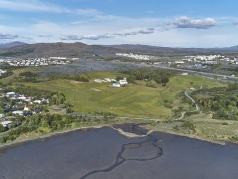Yfirlitsmynd yfir Keldnaland, sjór, gras, tré, vatn og hús.