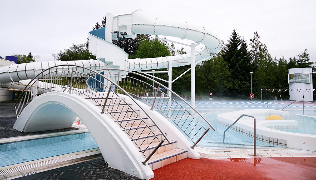 Walking bridge and slide at Árbæjarlaug