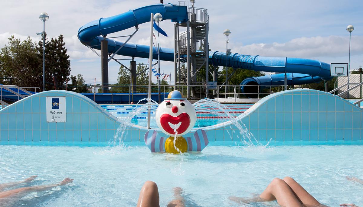 Large slide and clown fountain in children's wading pool at Grafarvogslaug