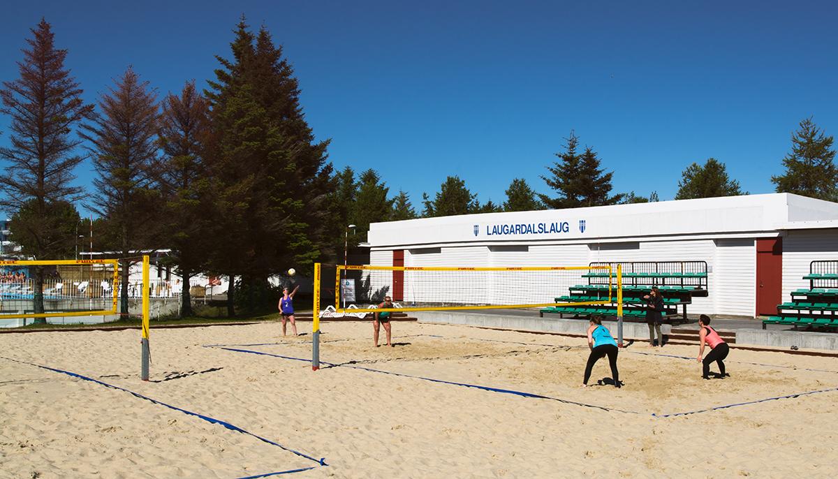 Four women playing beach volleyball on one of the beach volleyball courts at Laugardalslaug