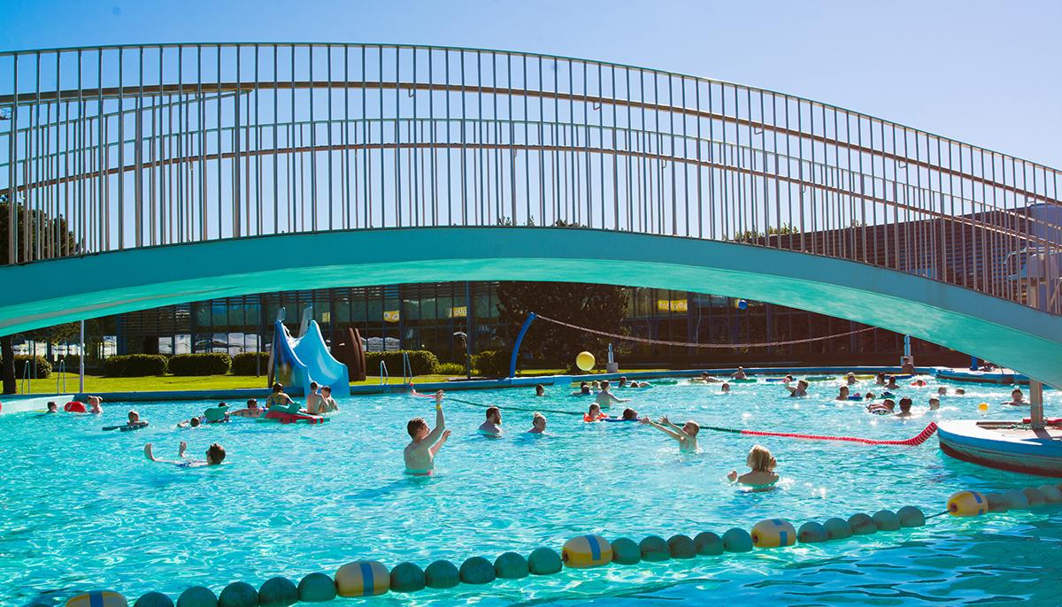 Children and adults playing in the children's pool at Laugardalslaug