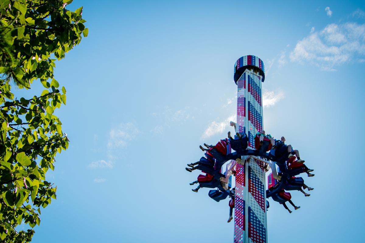 The drop tower in the Family Park with blue sky and green tree
