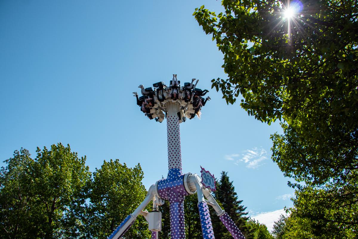 The drop tower with blue sky and green tree