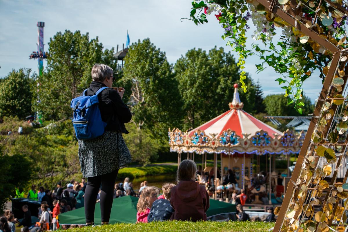 Woman taking photo of visitors in the Family Park