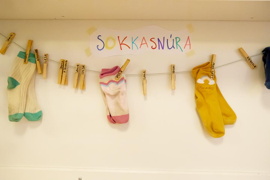 Socks on a clothesline with a sign above that reads "Sokkasnúra."