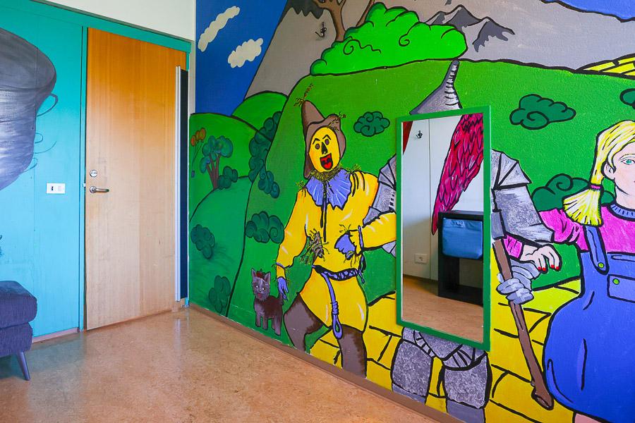 Wall decorated with images from The Wizard of Oz.