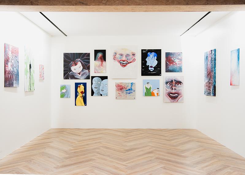 Photo of the gallery at Hitt Húsið. Many pictures on the wall.