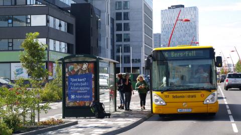 A public bus driving down Borgartún