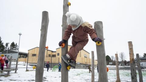 preschool child playing outside in winter