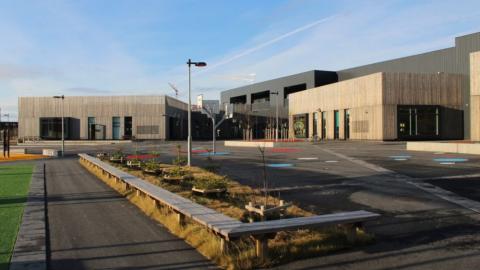 Gray, boxy houses where the youth center Fellið is located